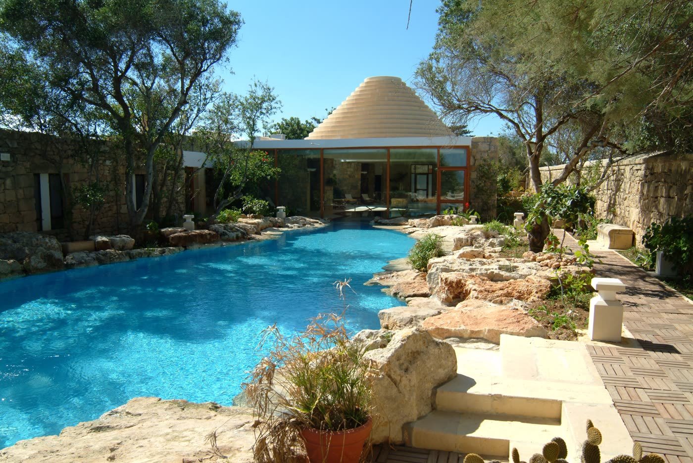 The heated lagoon-style pool beneath the trullo dome